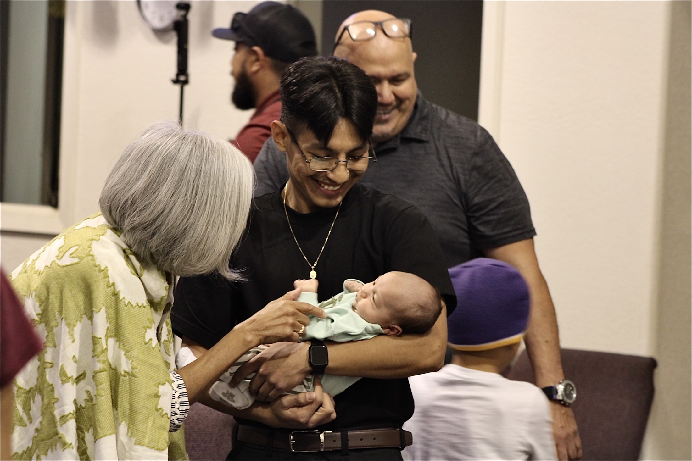 A Hope City family sharing their new baby with the church